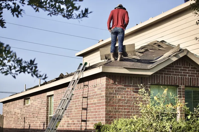 Professional roofer working on a residential roof in Yadkin